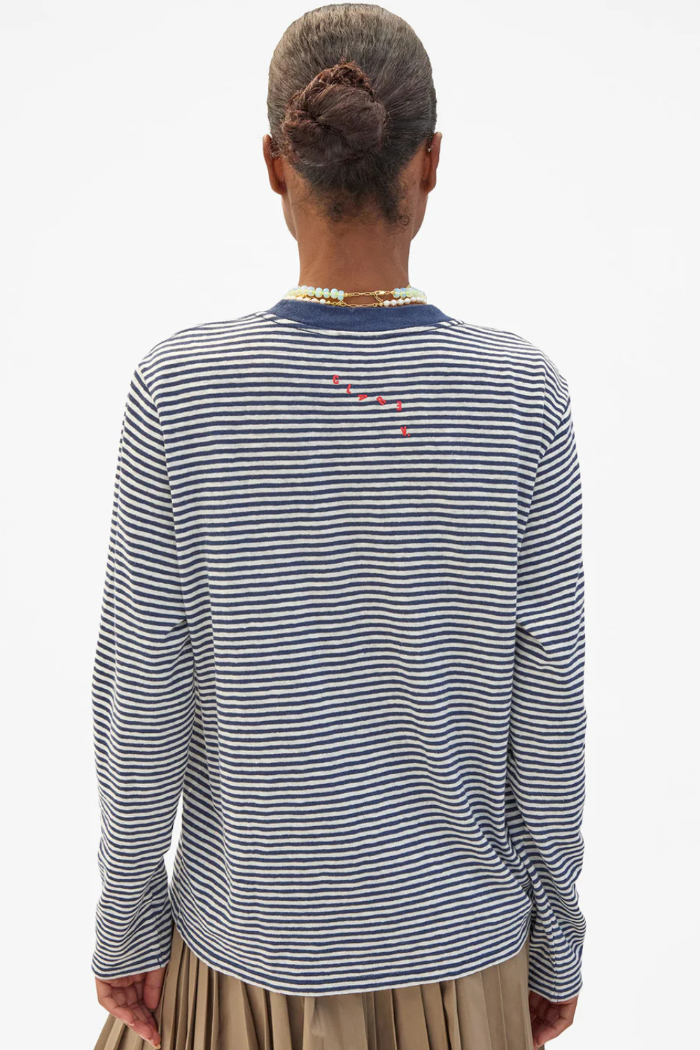 Model wearing Clare V. Cotton Linen Long Sleeve Tee Navy Cream Mini Stripe rear view
