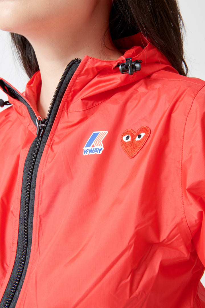 Lilly wearing Comme des Garçons PLAY K-Way Full Zip Red Emblem Unisex Jacket Red front/detail view