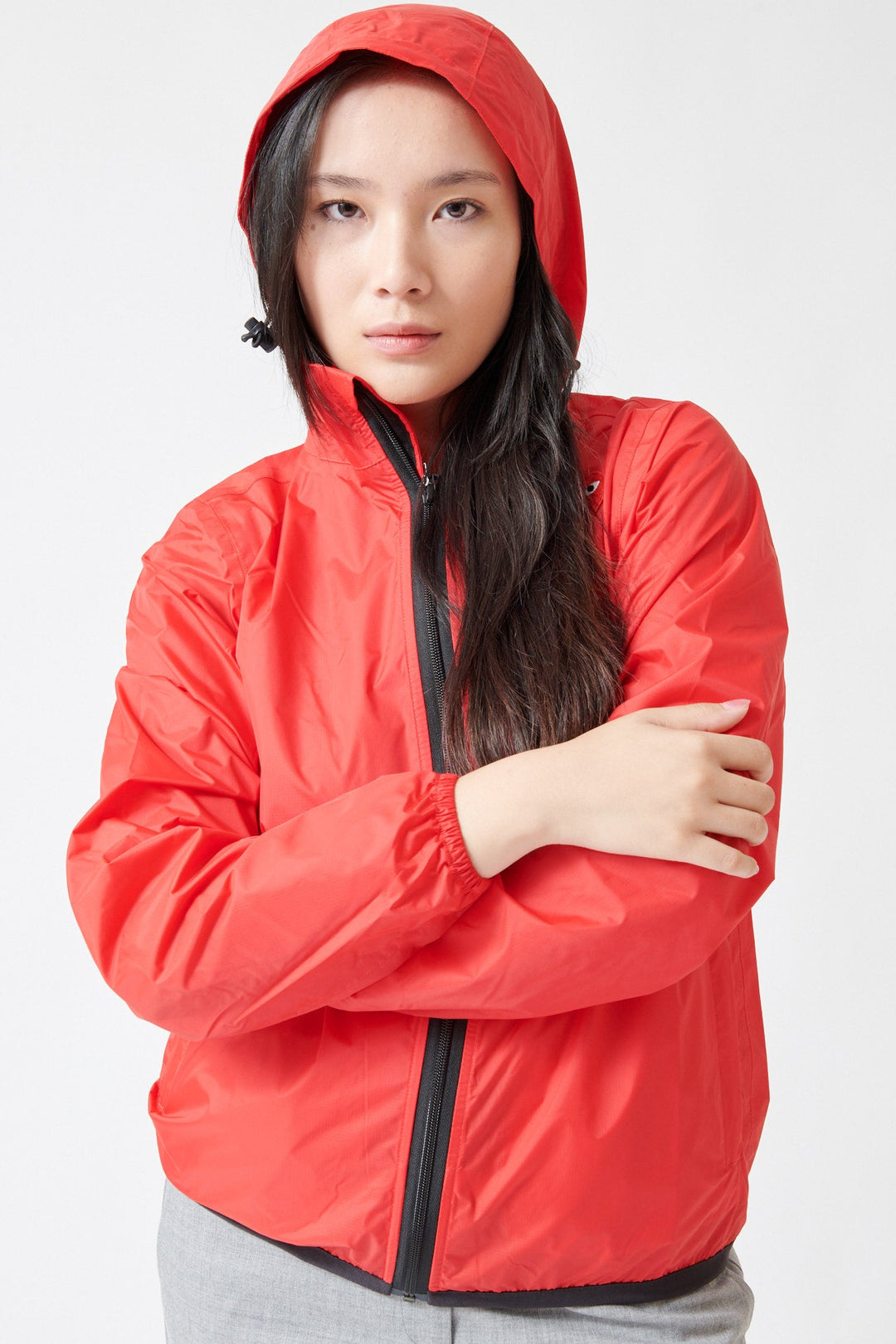 Lilly wearing Comme des Garçons PLAY K-Way Full Zip Red Emblem Unisex Jacket Red front view hood up
