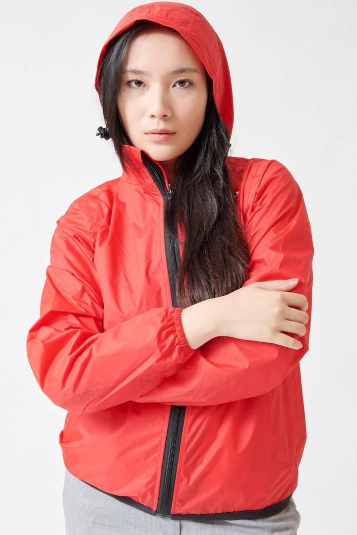 Lilly wearing Comme des Garçons PLAY K-Way Full Zip Red Emblem Unisex Jacket Red front view hood up