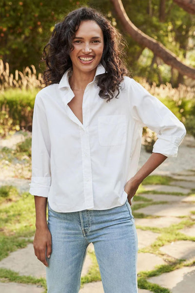 Front view of model wearing white button-up shirt