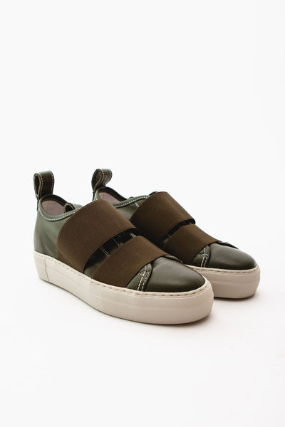 front side view of dark green sneakers with elastic straps