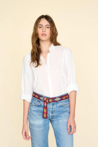 Front view of model wearing white long-sleeved button down shirt