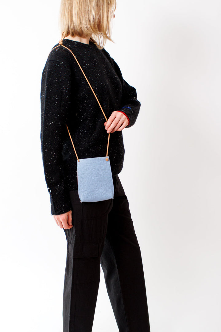 Madi wearing B. May Cell Pouch front view