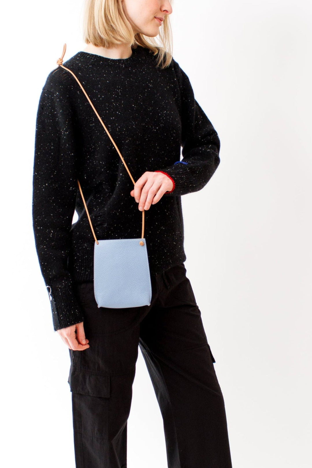 Madi wearing B. May Cell Pouch front view