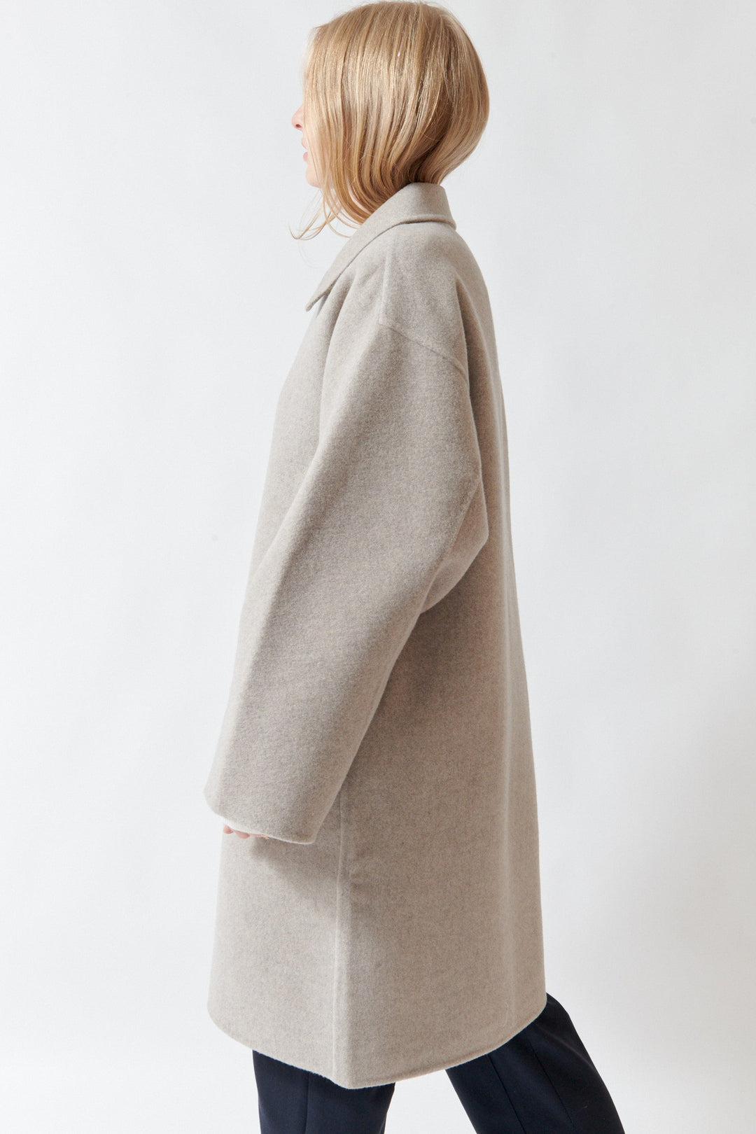 Madi wearing Sofie D'Hoore Carmine Long Jacket side view