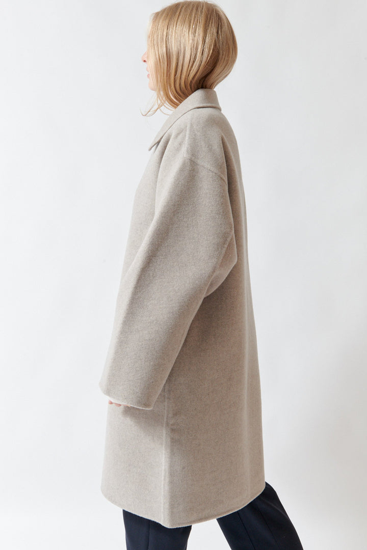 Madi wearing Sofie D'Hoore Carmine Long Jacket side view