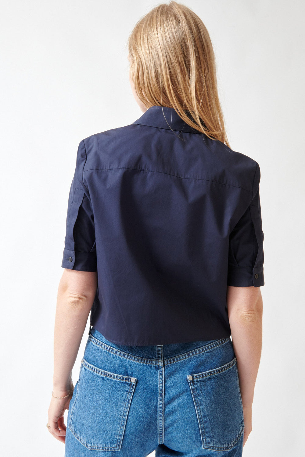 Madi wearing TWP Short Lived Placket Shirt With Cherry Pleats rear view