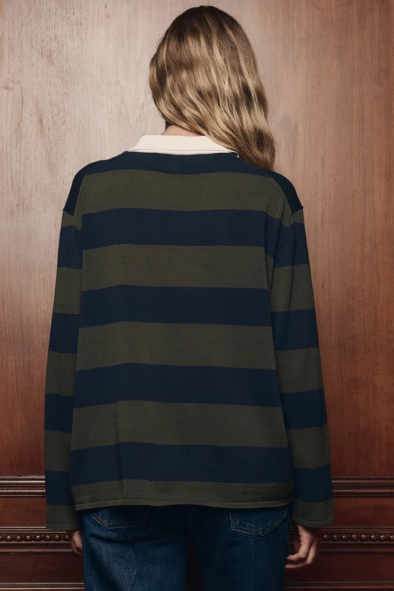 Model wearing The Great The Academy Polo Sweater Army League Stripe rear view