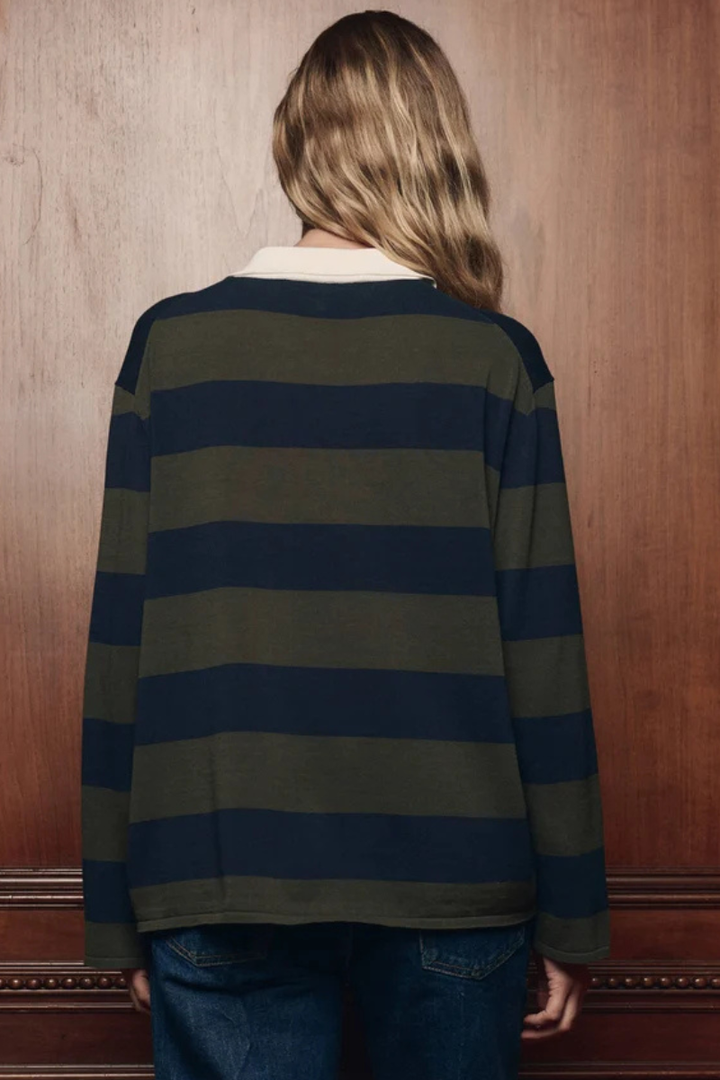 Model wearing The Great The Academy Polo Sweater Army League Stripe rear view