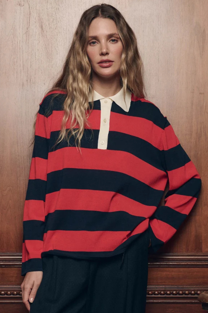 Model wearing The Great The Academy Polo Sweater Hot Red League Stripe front view
