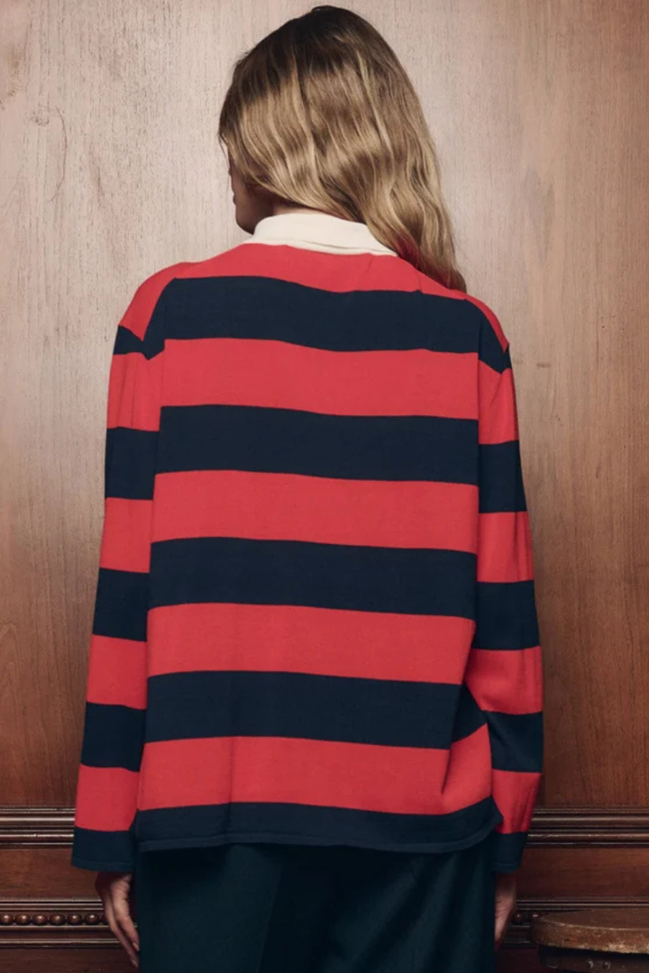 Model wearing The Great The Academy Polo Sweater Hot Red League Stripe rear view