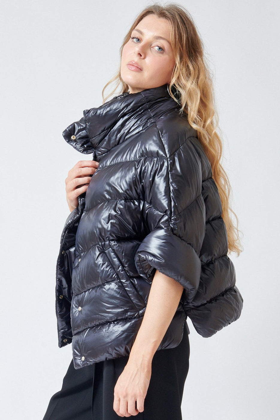 Mari wearing Herno Mid Sleeve Puffer Jacket With Added Arm Warmer Sleeve Black side view