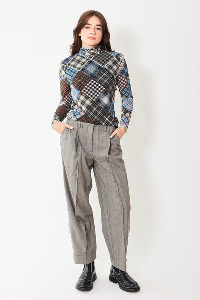 Ganni Herringbone Suiting Relaxed Pleated Pants, modeled from the front