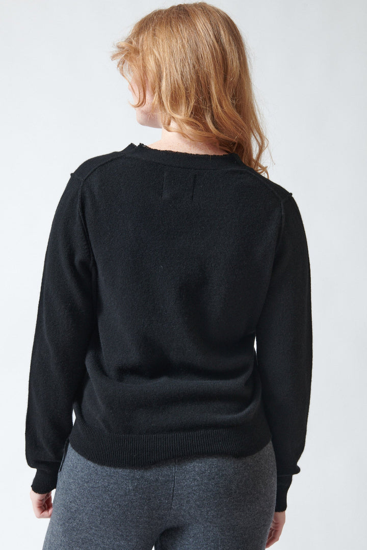 Waverly wearing Jumper 1234 Cashmere Distressed Vee Cardigan rear view