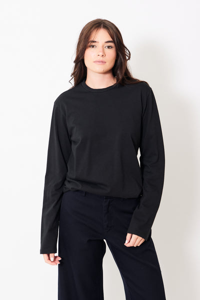 Front view of model wearing long sleeve black tee shirt