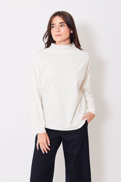 Front view of model wearing long sleeve winter white mock neck tee