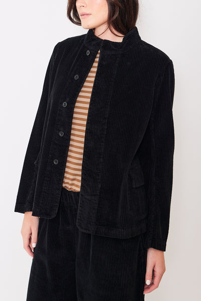 Close up front view of model wearing black button-up corduroy jacket