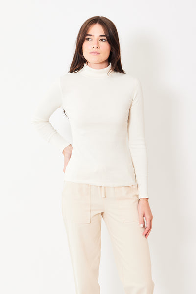 Front view of model wearing off-white long sleeve turtleneck tee 