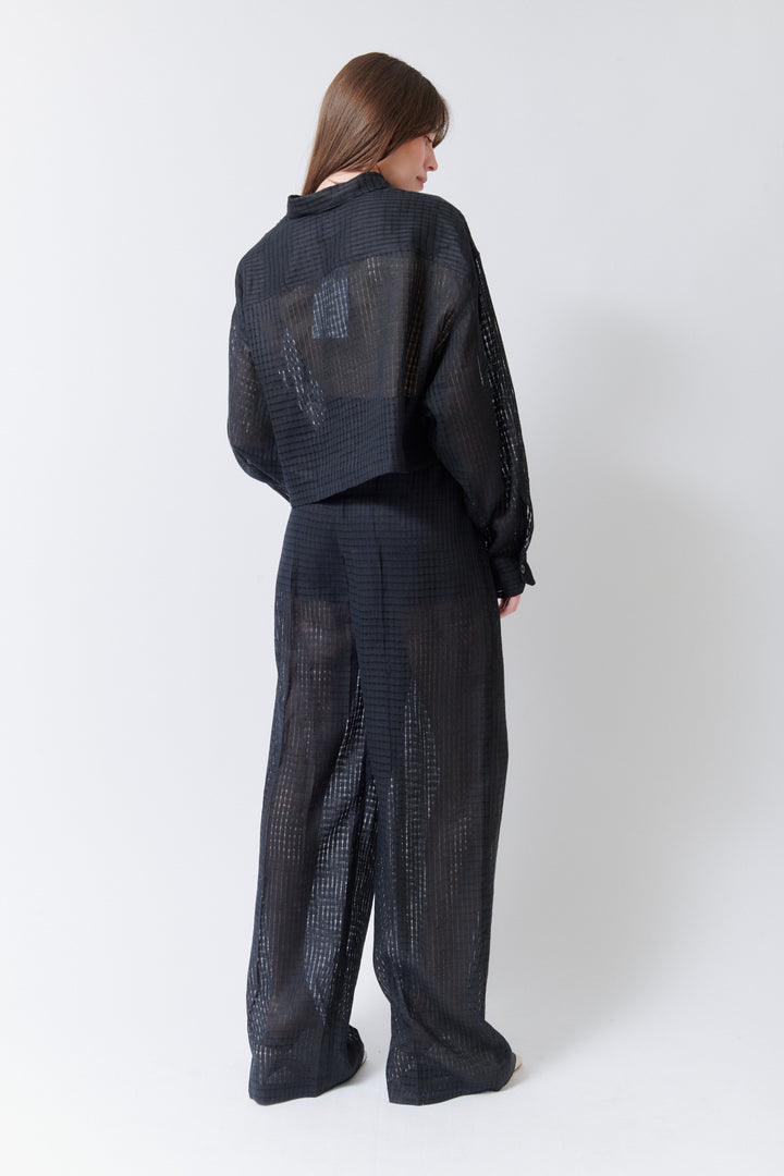 Angela wearing Mantu Lanisha Pleated Trousers rear view