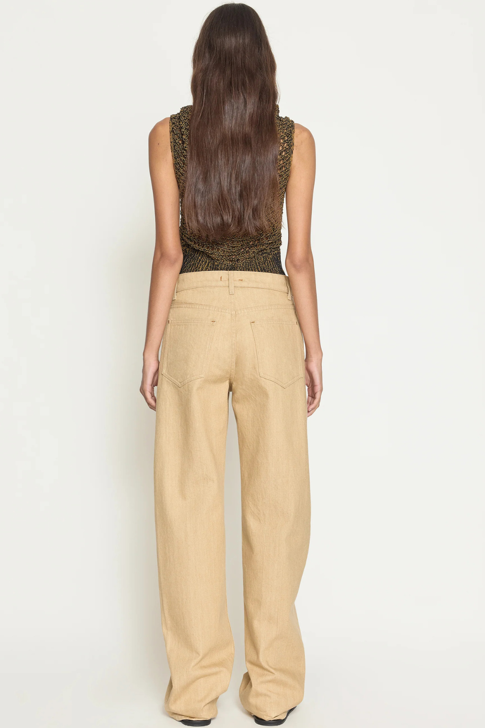 Model wearing OSSOU Rider Jean Clay Wash rear view