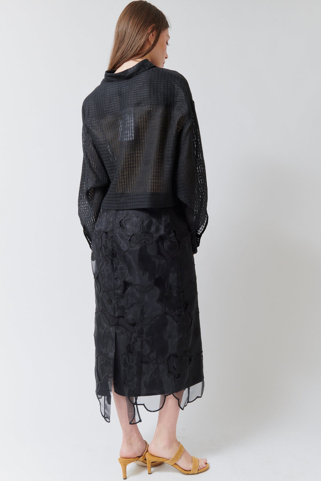 Angela wearing Meimeij Floral Cut Out Overlay Skirt Black rear view