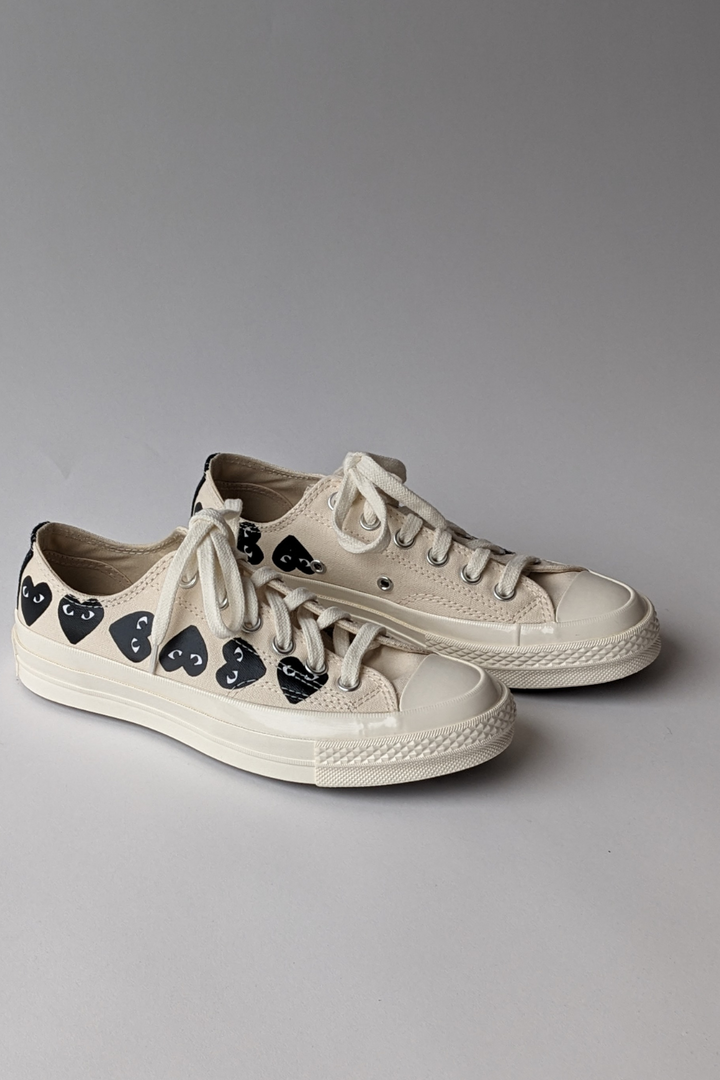 front, side view of Comme des Garçons PLAY Multi Heart Converse Chuck Taylor Low Top