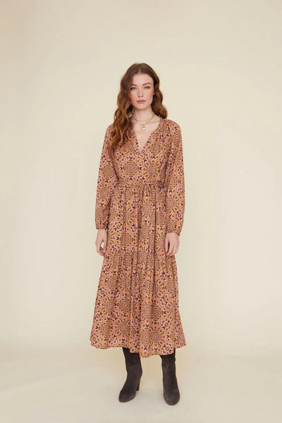 Front view of model wearing patterned midi length dress