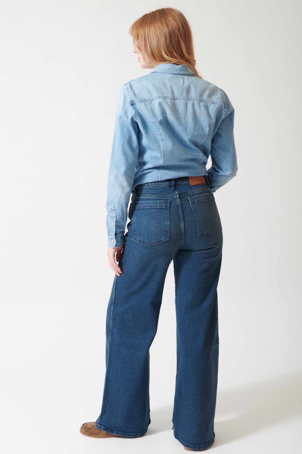 Waverly wearing Apiece Apart Full Length Merida Jean in Oona Wash, rear view.