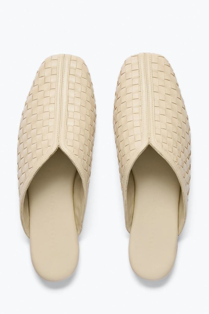 Flat lay of Frēda Salvador Saanvi Flat Mule Vanilla Woven Calf front view