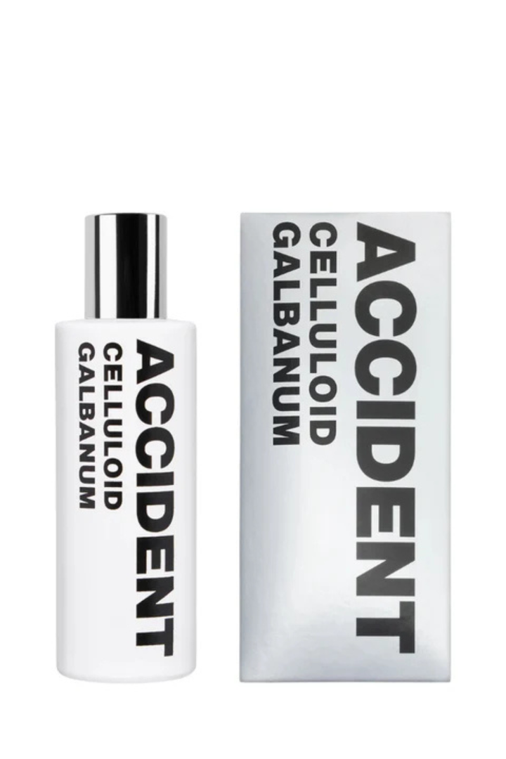 Flat lay of Comme des Garçons Eau de Parfum ACCIDENT Celluloid Galbanum front bottle and box view