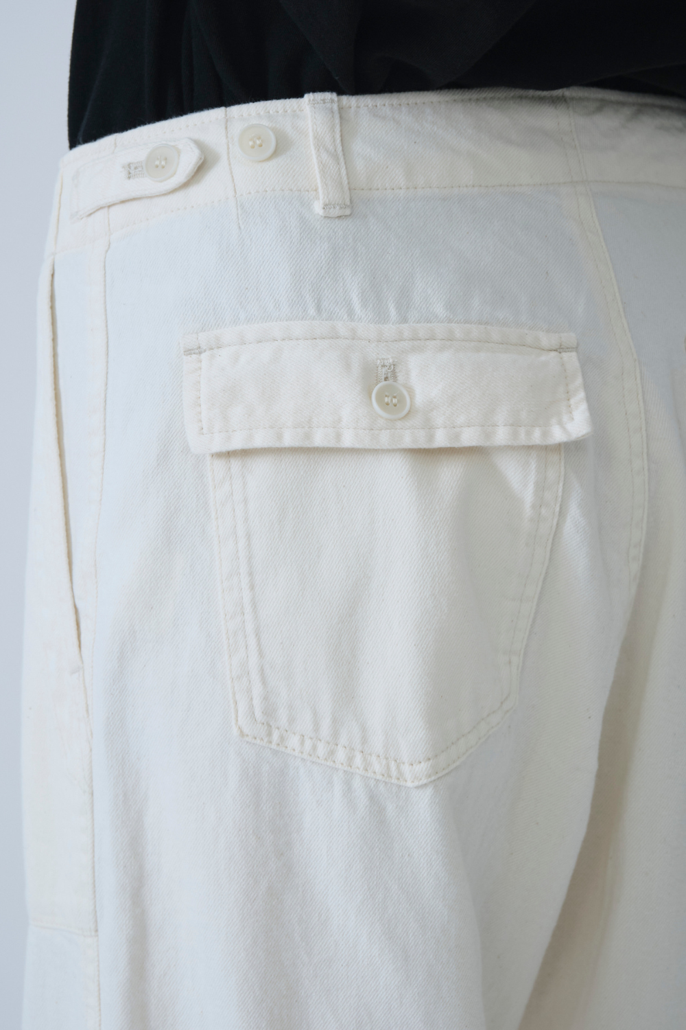 Model wearing Pas de Calais 8oz Natural Denim Baker Pants rear/detail view