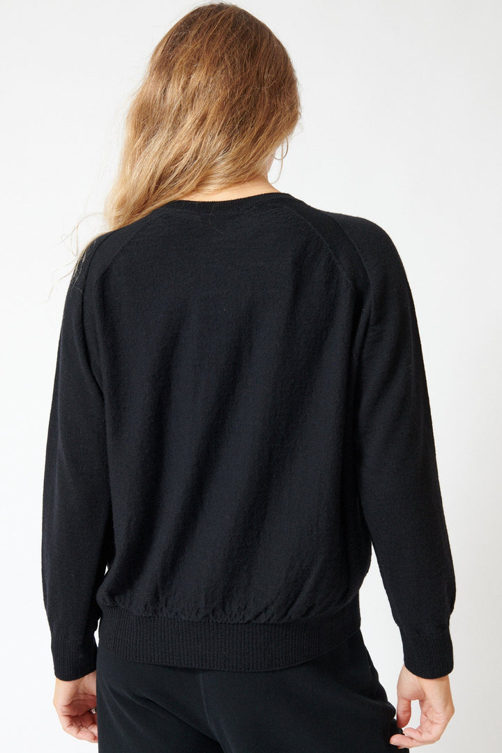 Mari wearing Pas de Calais Airy Merino Wool Patterned Panel Switch Crewneck Pullover Black rear view