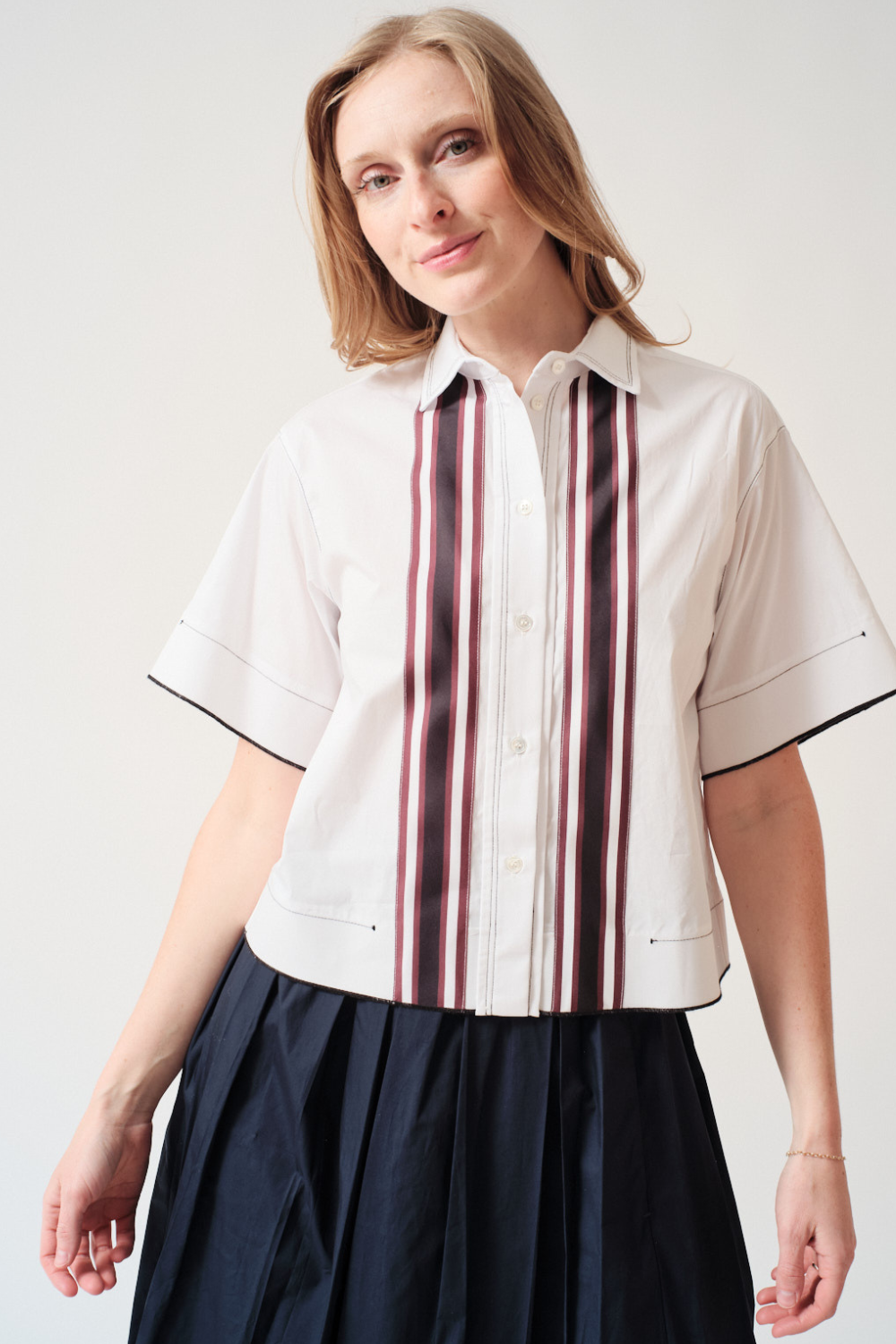 Madi wearing Tela Gimmy Shirt Striped front view
