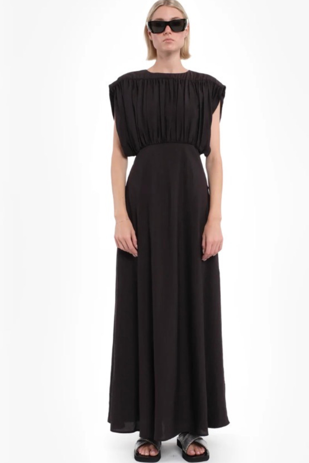 Woman wearing a brown dress on a white background