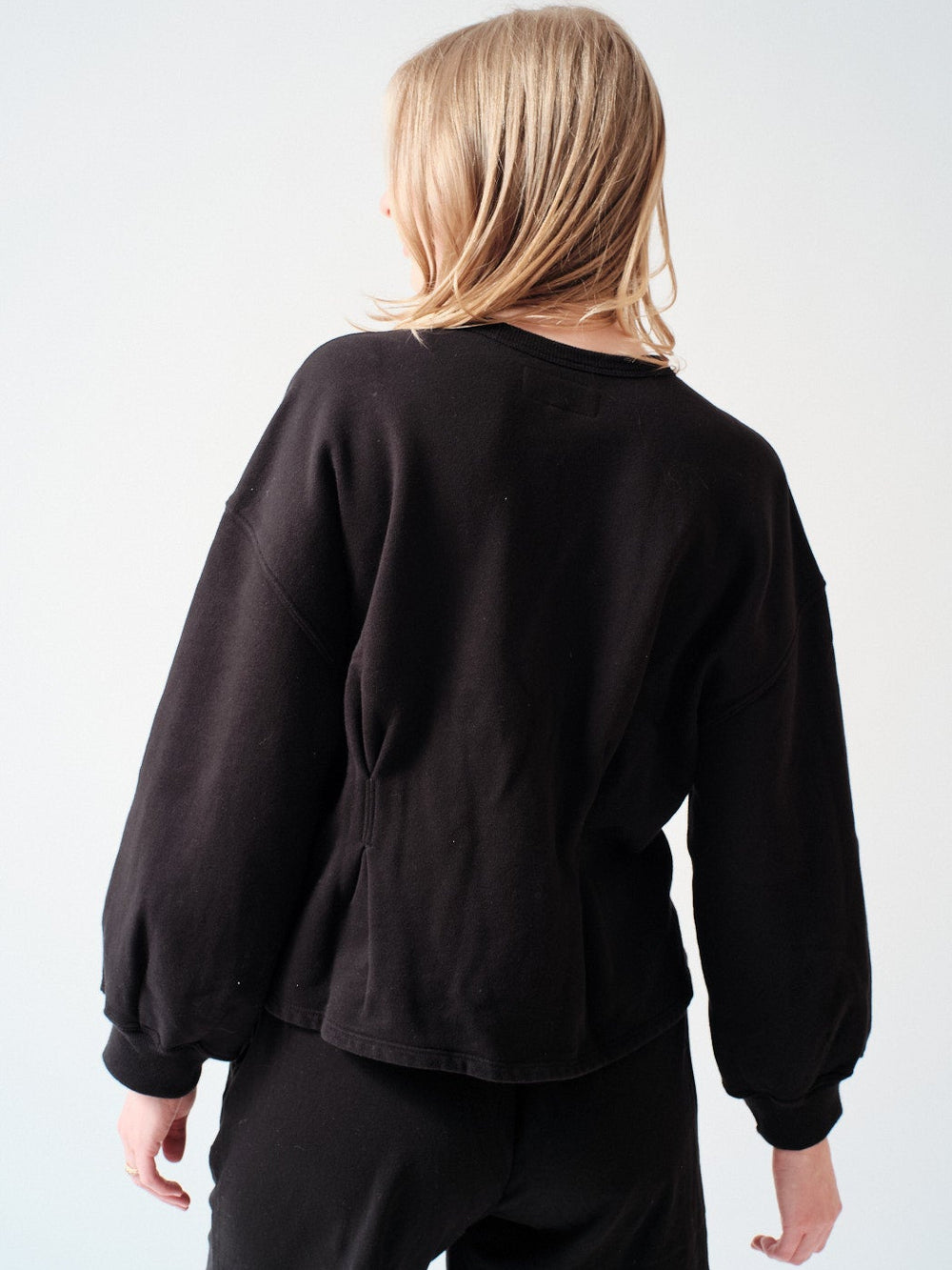 Madi wearing The Great The Slouchy Corset Sweatshirt rear view