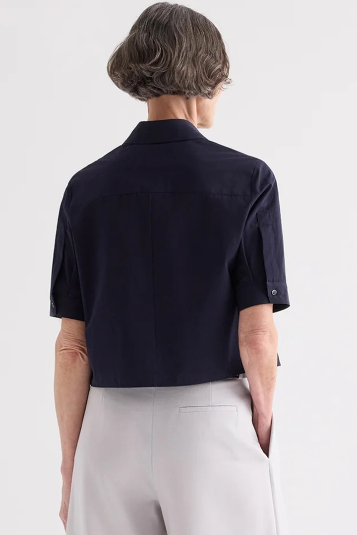 Model wearing TWP Short Lived Placket Shirt With Cherry Pleats Midnight rear view