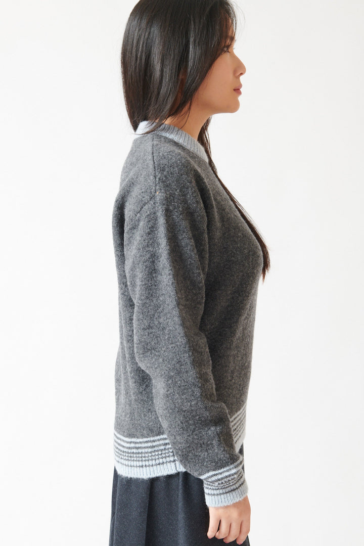 Lilly wearing Tela Engin Sweater side view