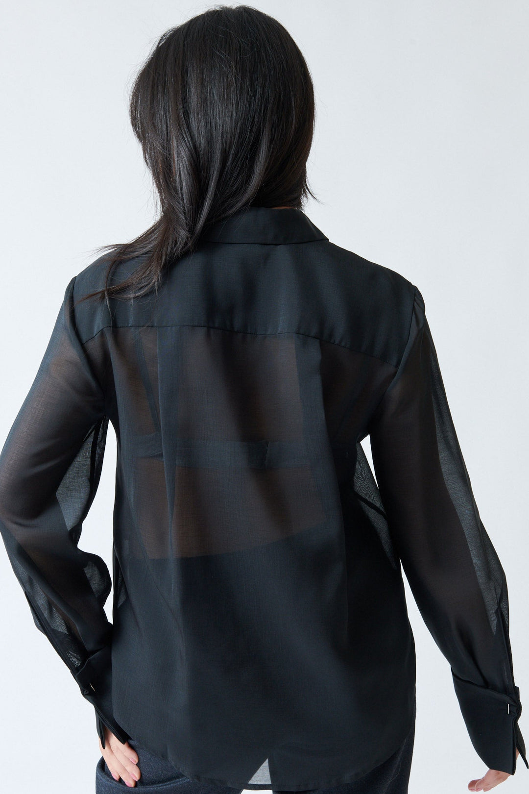 Lilly wearing Tela Opal Shirt rear view