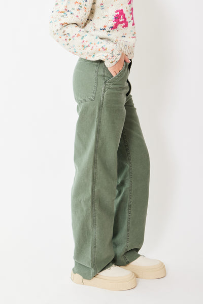 Side view of model wearing army green frayed hem pants