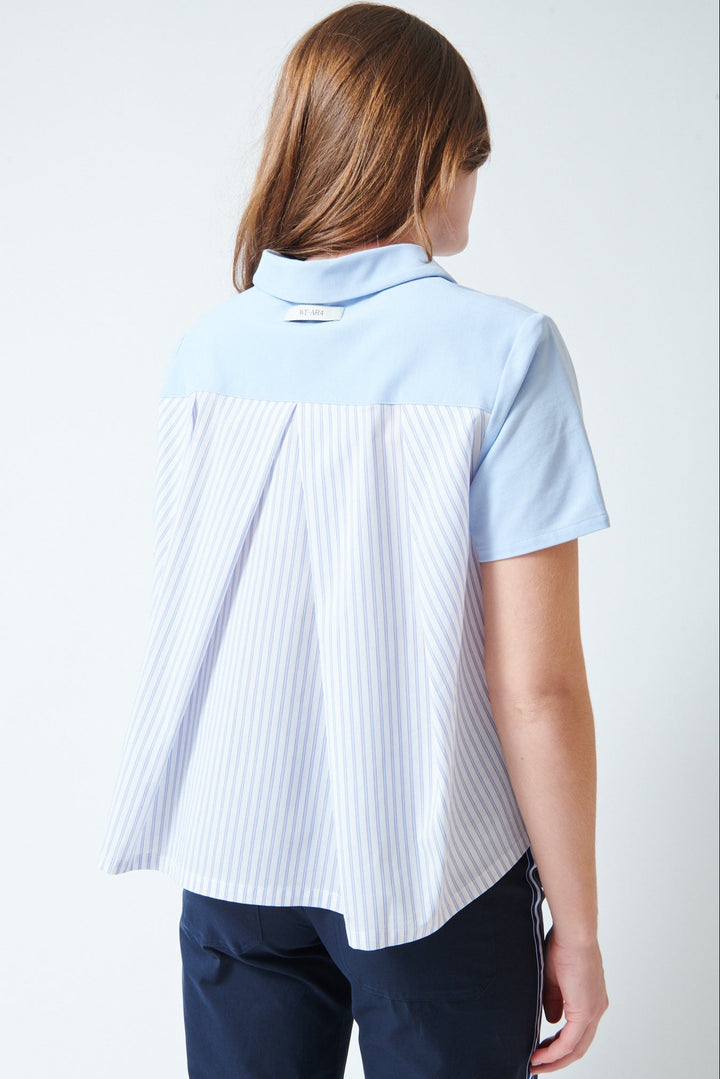 Julia wearing WE-AR4 The Media Polo Pale Blue Multi rear view