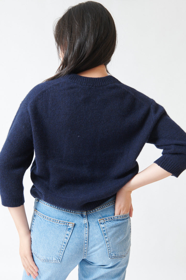 Lilly wearing White + Warren Featherweight Cashmere Scoop Tee Deep Navy rear view