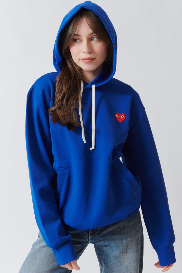 Angela wearing Comme des Garçons PLAY Red Emblem Hooded Sweatshirt Navy front view with hood up