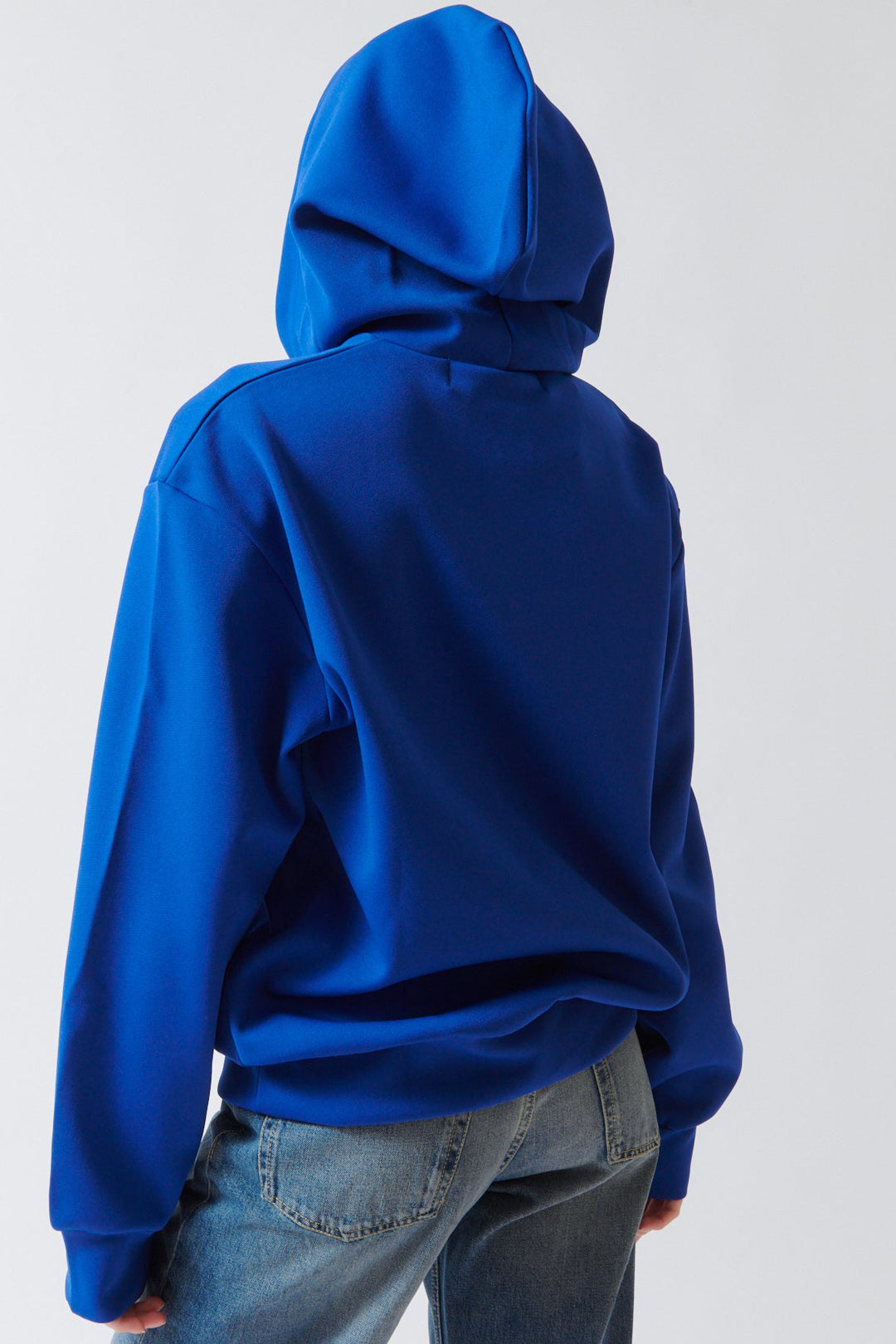 Angela wearing Comme des Garçons PLAY Red Emblem Hooded Sweatshirt Navy rear view