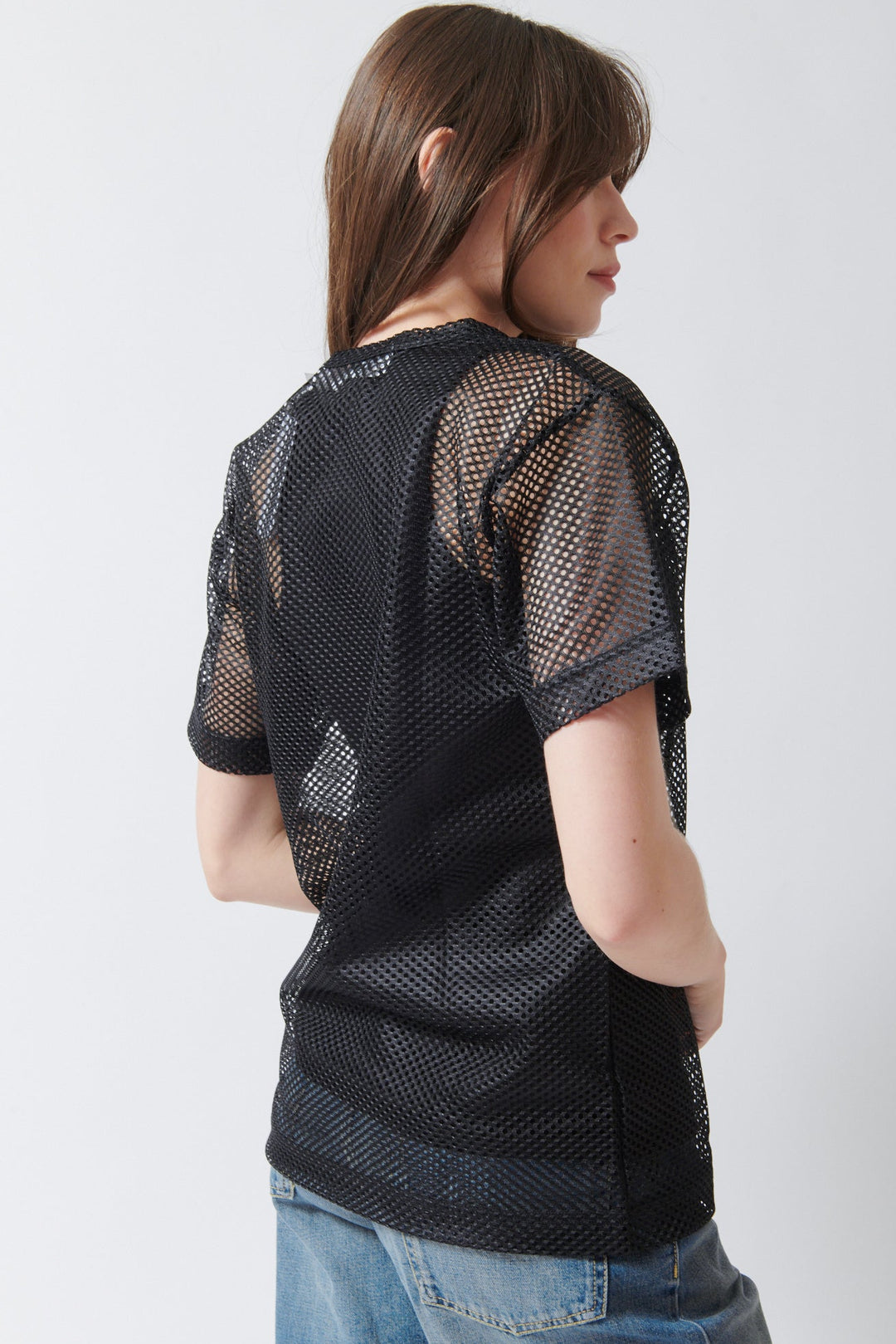 Angela wearing Comme des Garçons PLAY Red Heart Emblem Mesh Tee Shirt Black rear view