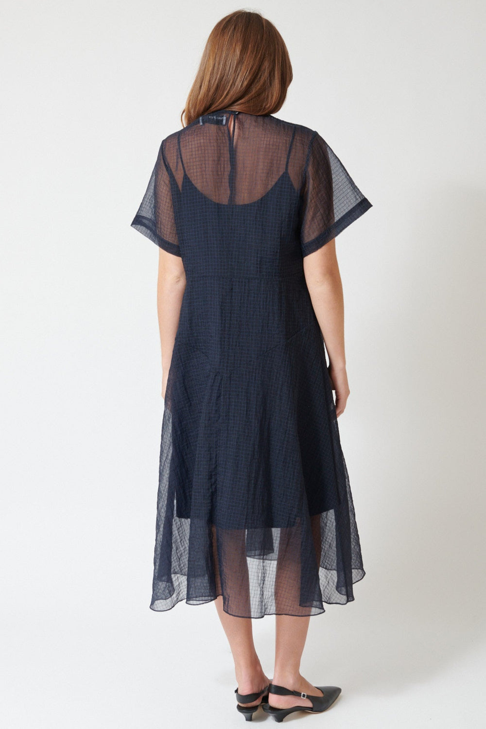 Julia wearing Fabiana Pigna Lumi Italian Techno Organza Dress in Midnight, rear view.