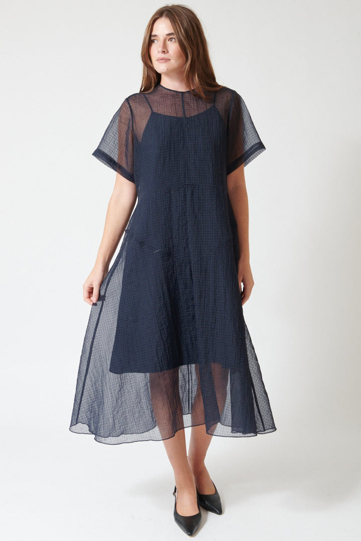 Julia wearing Fabiana Pigna Lumi Italian Techno Organza Dress in Midnight, front view.
