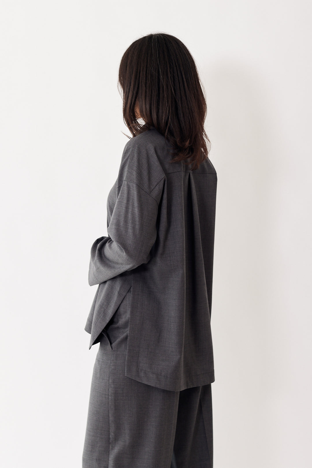 Amanda wearing Odeeh Virgin Wool Front And Side Button Blouse rear view