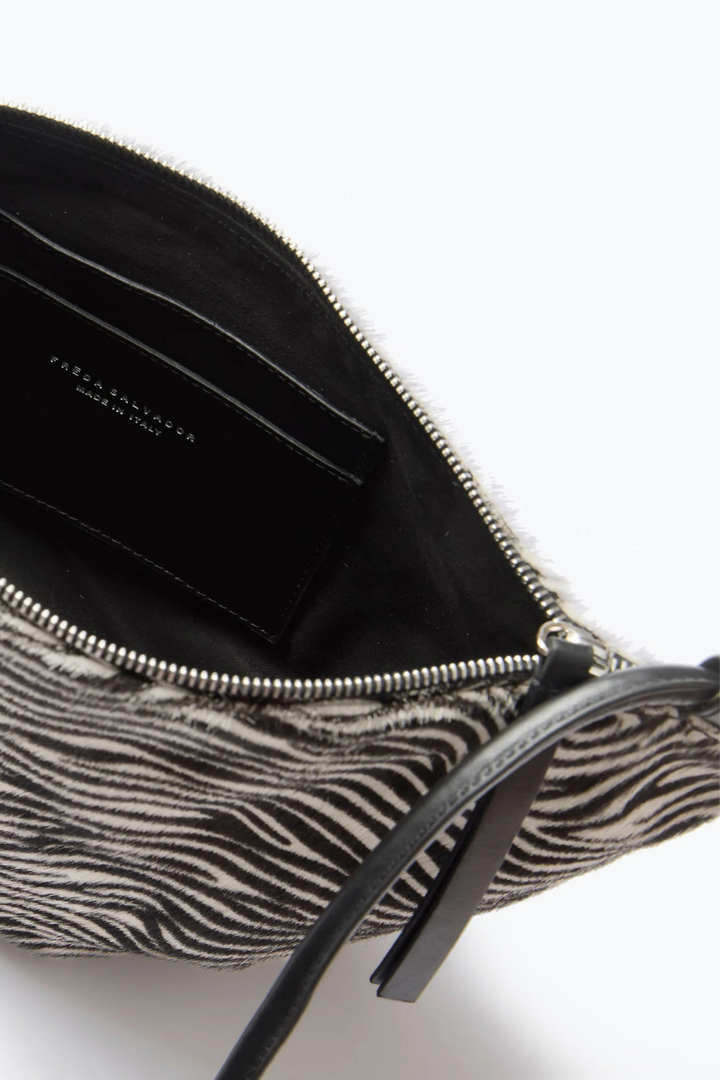 Flat lay of Frēda Salvador Elodie Crescent Bag Zebra Haircalf inside view