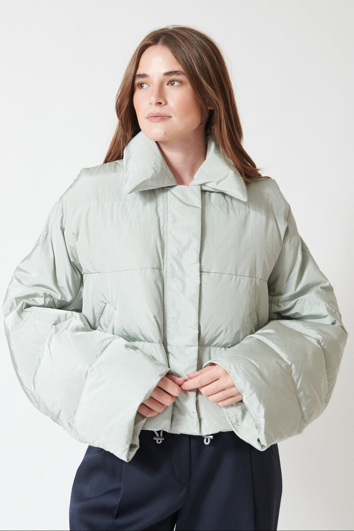 Julia wearing Christian Wijnants Jani Coat in Pigeon, front view with arms half folded.